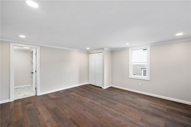 basement with dark wood-type flooring and ornamental molding