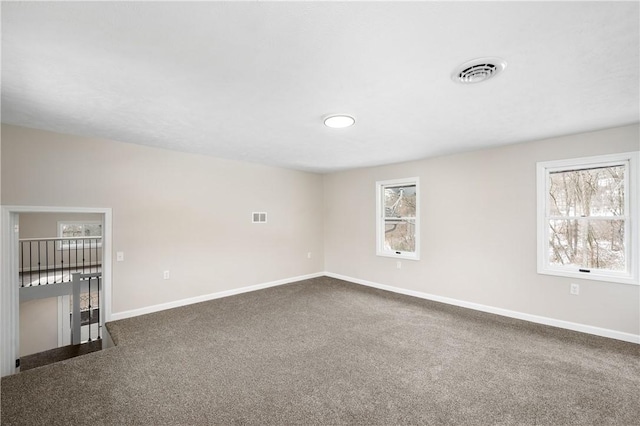 carpeted empty room featuring plenty of natural light