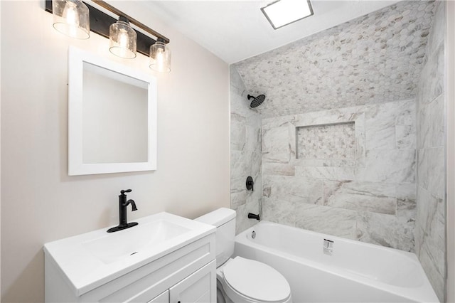 full bathroom featuring toilet, vanity, and tiled shower / bath