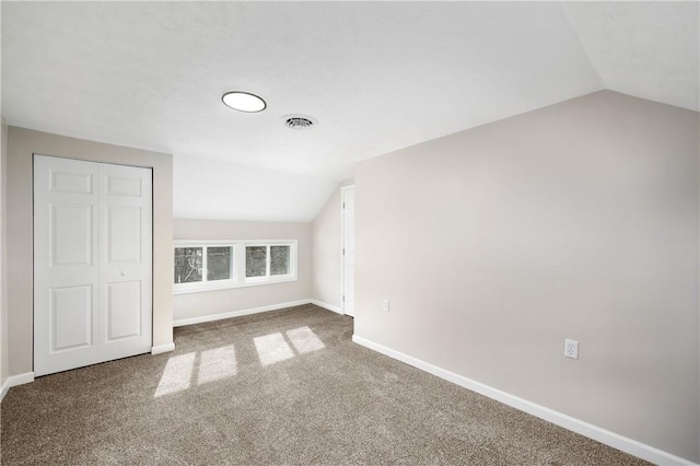 bonus room with carpet flooring and lofted ceiling