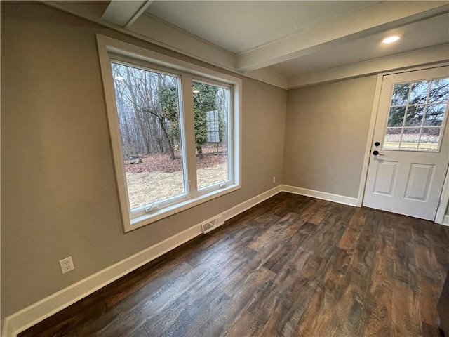 foyer entrance with beamed ceiling and dark hardwood / wood-style flooring