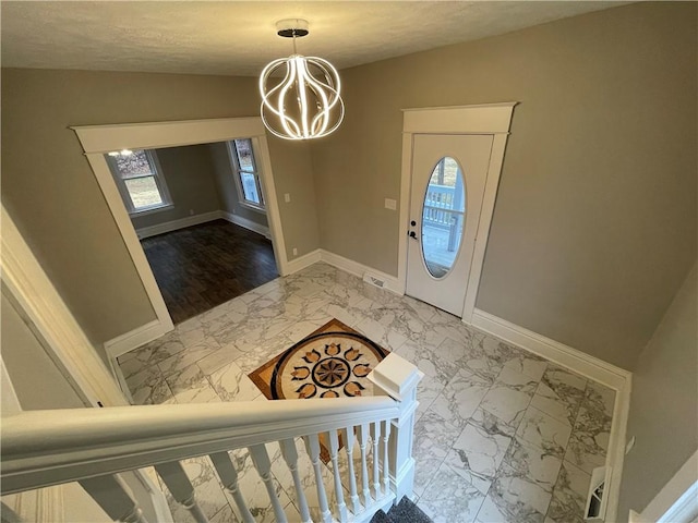 entryway with a notable chandelier