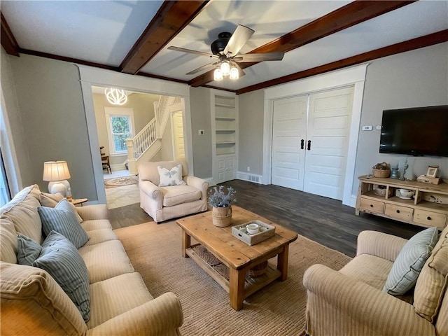 living room featuring ceiling fan, hardwood / wood-style floors, beamed ceiling, and ornamental molding