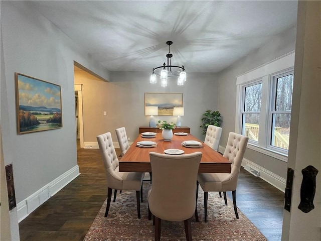 dining room with a notable chandelier and dark hardwood / wood-style floors