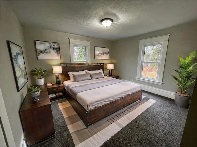 carpeted bedroom featuring a textured ceiling