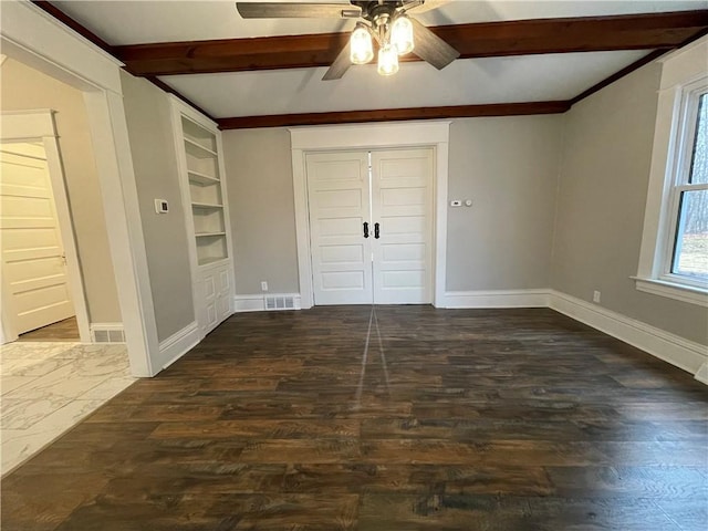 unfurnished bedroom with ceiling fan, beamed ceiling, and dark hardwood / wood-style floors