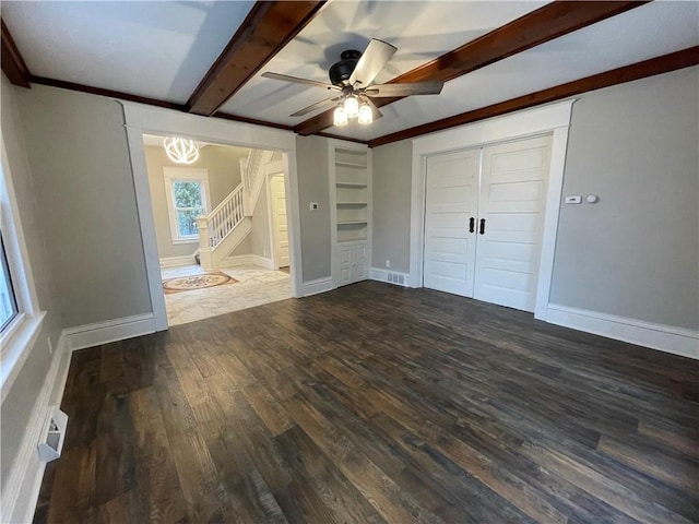 unfurnished bedroom with beam ceiling, dark hardwood / wood-style flooring, a closet, and ceiling fan