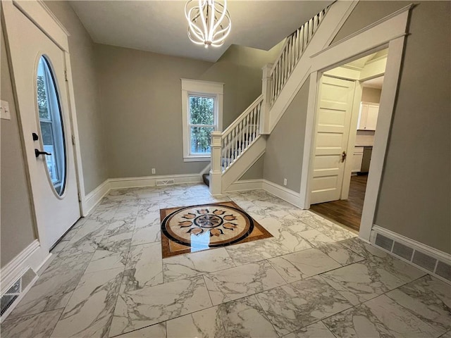 foyer with an inviting chandelier