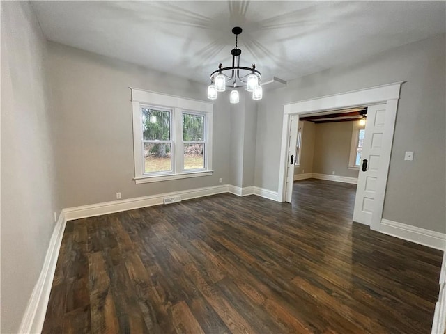 unfurnished dining area with dark hardwood / wood-style flooring and a notable chandelier