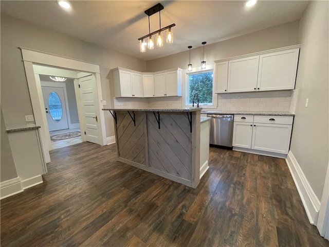 kitchen featuring white cabinetry, dishwasher, light stone countertops, hanging light fixtures, and dark wood-type flooring