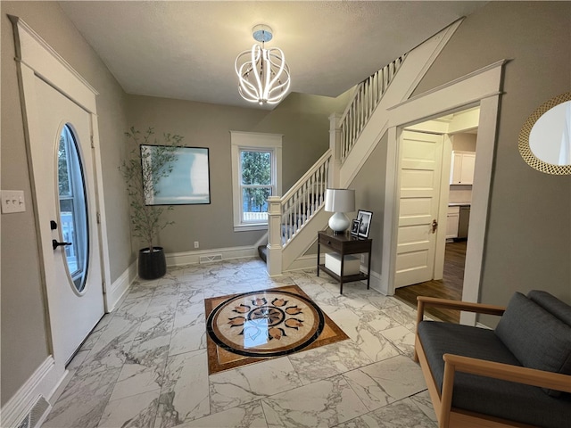 foyer entrance with an inviting chandelier