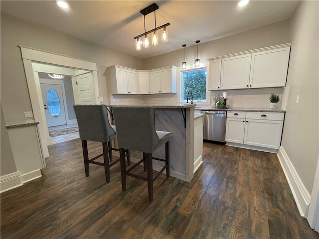 kitchen with dishwasher, white cabinets, hanging light fixtures, light stone counters, and dark hardwood / wood-style flooring