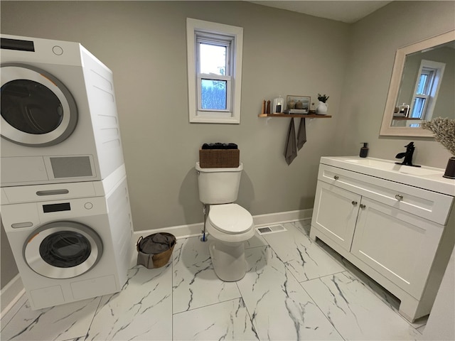 washroom with sink and stacked washer and clothes dryer