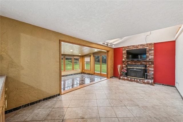 unfurnished living room featuring a textured ceiling, tile patterned flooring, vaulted ceiling, and a brick fireplace