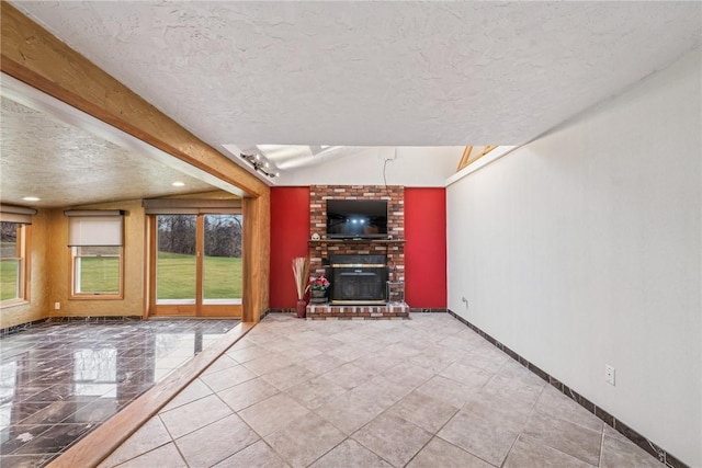 unfurnished living room with a fireplace, a textured ceiling, and lofted ceiling with beams