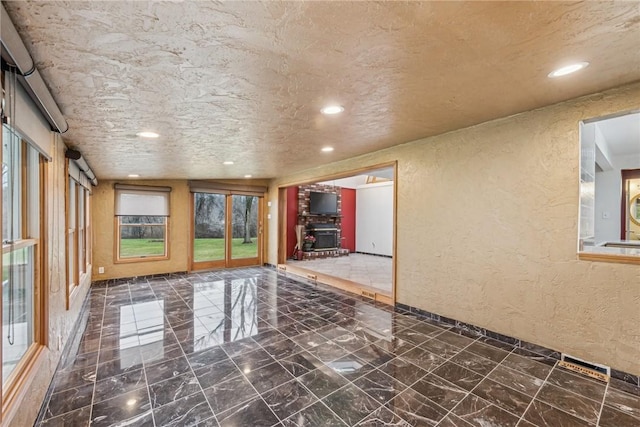 unfurnished room with a textured ceiling