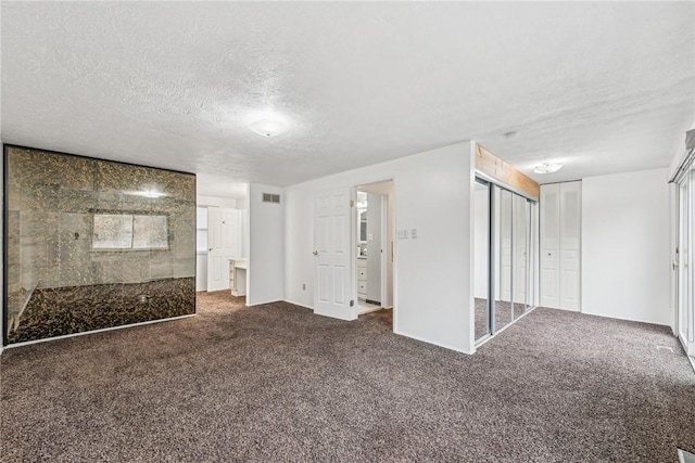 interior space featuring carpet and a textured ceiling