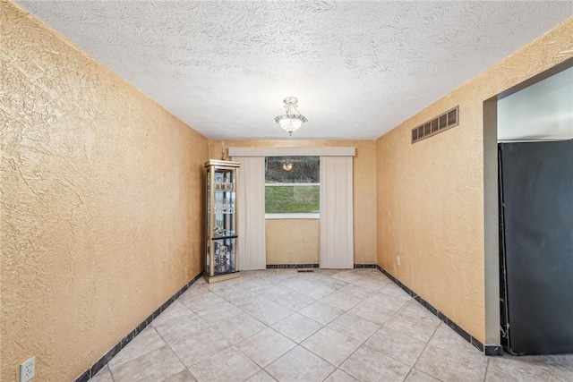 empty room featuring a textured ceiling