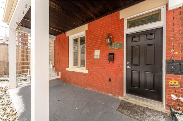 view of exterior entry featuring a porch