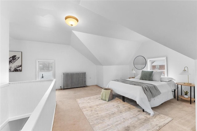 bedroom featuring light carpet, radiator heating unit, vaulted ceiling, and multiple windows