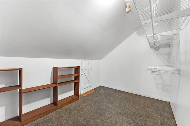 bonus room featuring dark carpet and lofted ceiling