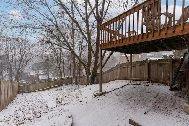 yard covered in snow featuring a wooden deck