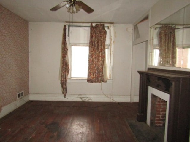 interior space featuring hardwood / wood-style flooring, ceiling fan, and a fireplace