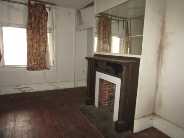 unfurnished living room featuring a fireplace and hardwood / wood-style floors