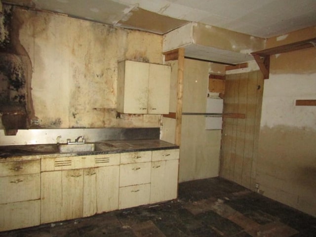 kitchen with cream cabinetry and sink