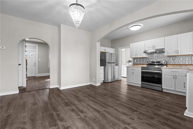 kitchen featuring dark hardwood / wood-style flooring, tasteful backsplash, stainless steel appliances, a notable chandelier, and white cabinets