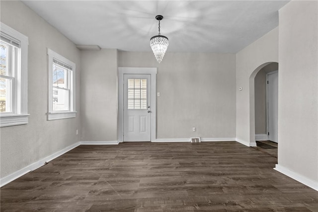 entrance foyer with a chandelier and dark wood-type flooring