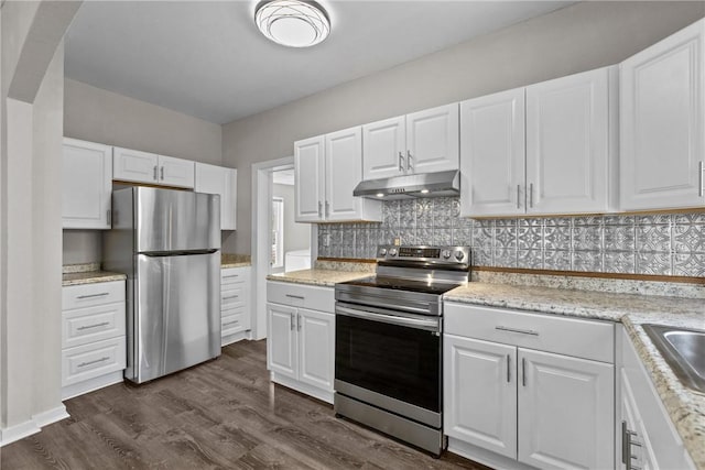 kitchen with backsplash, dark wood-type flooring, white cabinets, light stone counters, and stainless steel appliances