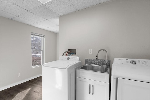 washroom with dark hardwood / wood-style flooring, separate washer and dryer, sink, and cabinets