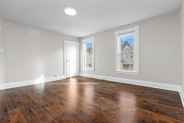 unfurnished room featuring dark wood-type flooring