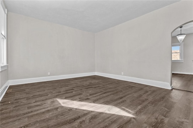 spare room featuring dark wood-type flooring