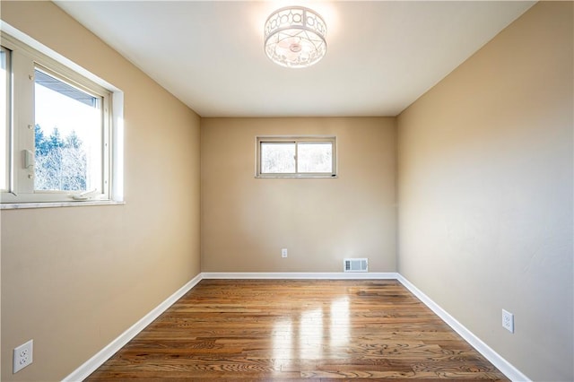 unfurnished room with hardwood / wood-style floors