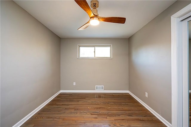 spare room featuring dark hardwood / wood-style floors and ceiling fan