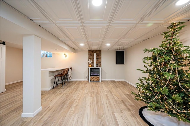 bar with light hardwood / wood-style floors