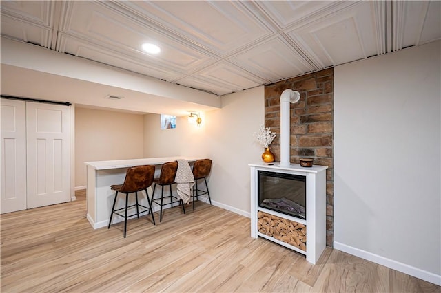 bar with light hardwood / wood-style floors