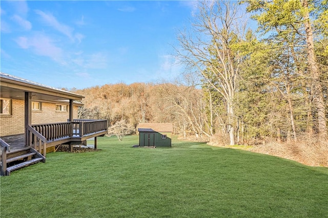 view of yard with a storage shed and a wooden deck