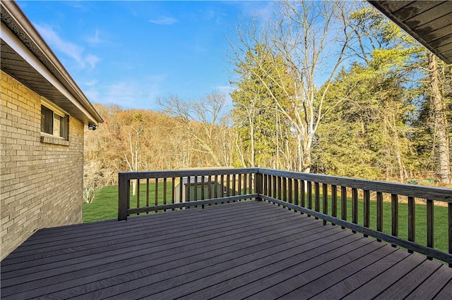 wooden terrace featuring a yard