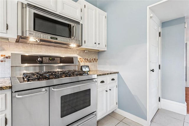 kitchen featuring white cabinets, backsplash, light tile patterned flooring, and stainless steel appliances