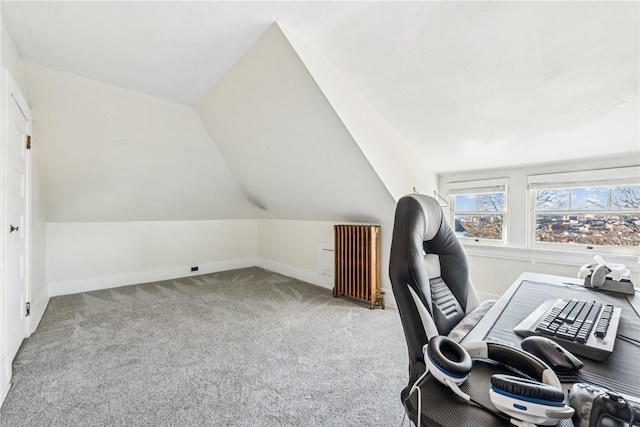 carpeted office featuring radiator and lofted ceiling