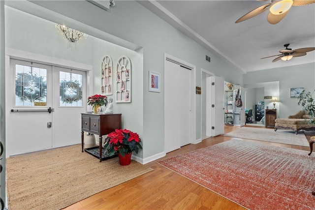 foyer entrance with ceiling fan and wood-type flooring