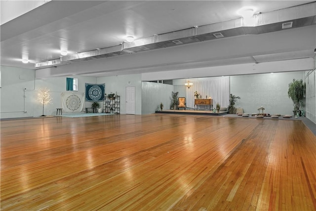 misc room featuring hardwood / wood-style floors and a chandelier