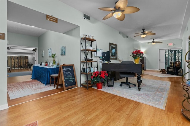 office with hardwood / wood-style flooring and a fireplace