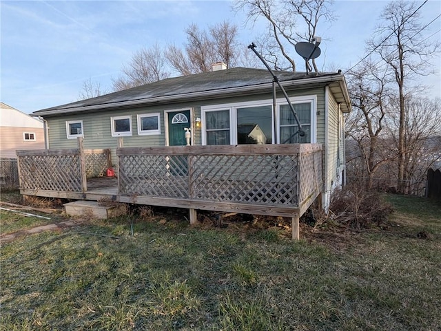 back of property featuring a lawn