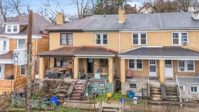 back of property with a porch and cooling unit