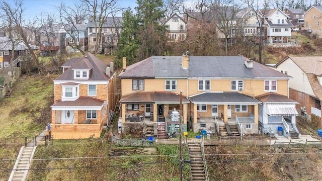 rear view of property featuring covered porch