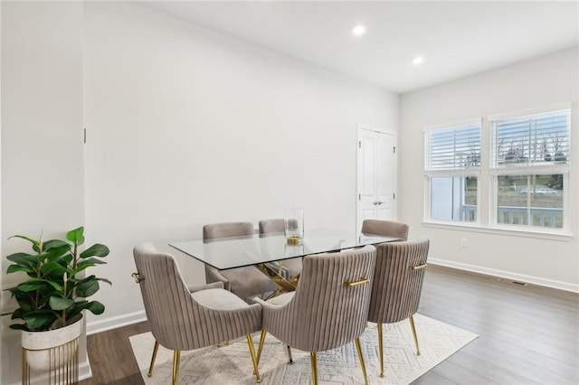 dining room with dark hardwood / wood-style flooring